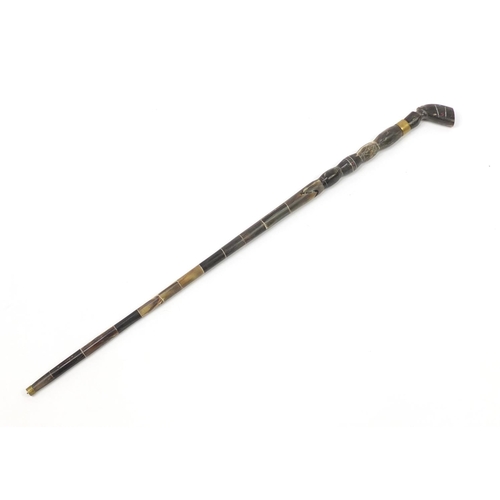 81 - Segmented horn walking stick with figural pommel, 94cm in length