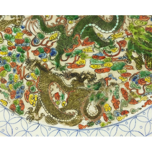 381 - Chinese porcelain charger hand painted in the famille verte palette with dragons amongst clouds, six... 