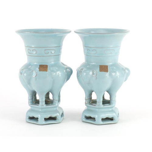 418 - Pair of Chinese porcelain archaic style vases on stands, with elephant heads, both with character ma... 