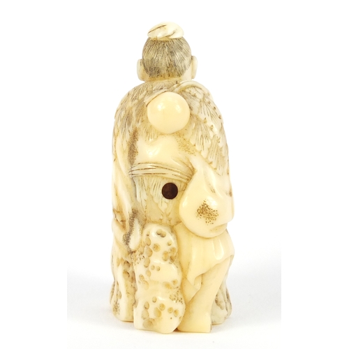 482 - Good Japanese carved ivory netsuke of a man seated on a rock, 5.2cm high