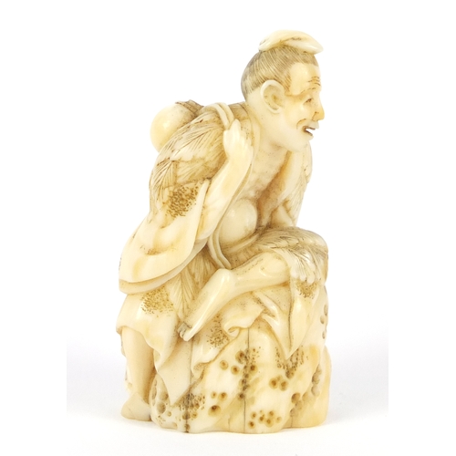 482 - Good Japanese carved ivory netsuke of a man seated on a rock, 5.2cm high