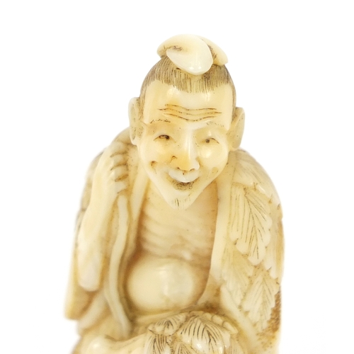 482 - Good Japanese carved ivory netsuke of a man seated on a rock, 5.2cm high