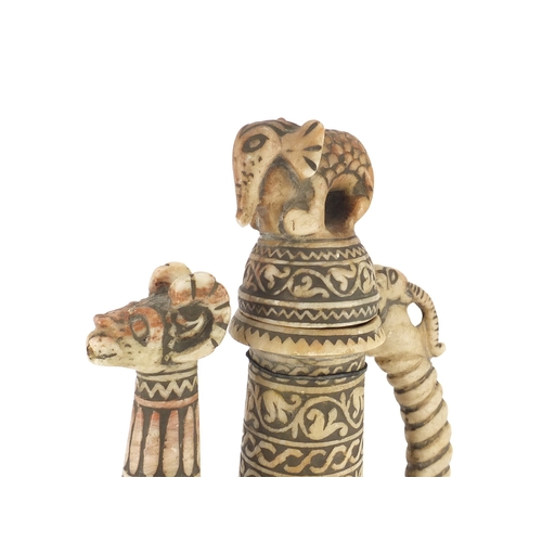528 - Islamic stone wine ewer, carved with rams, elephant and foliate motifs, 36cm high