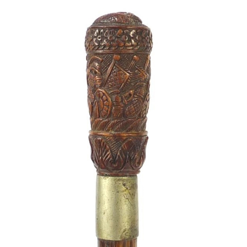 82 - Exotic wood walking stick having a coquilla nut pommel carved with Roman soldiers and an emperors he... 