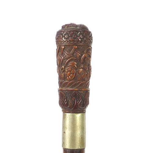 82 - Exotic wood walking stick having a coquilla nut pommel carved with Roman soldiers and an emperors he... 