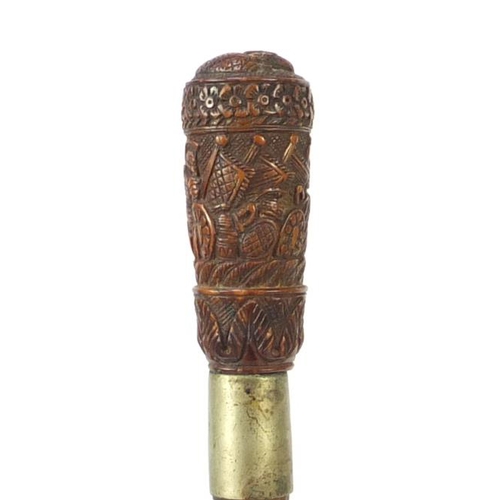 82 - Exotic wood walking stick having a coquilla nut pommel carved with Roman soldiers and an emperors he... 