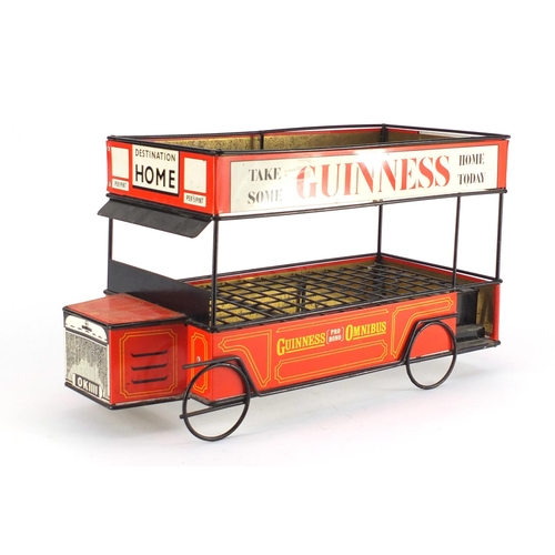 2144 - Vintage Guinness tin plate shop display bottle stand in the form of a bus, 47cm long