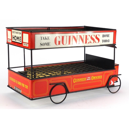 2144 - Vintage Guinness tin plate shop display bottle stand in the form of a bus, 47cm long