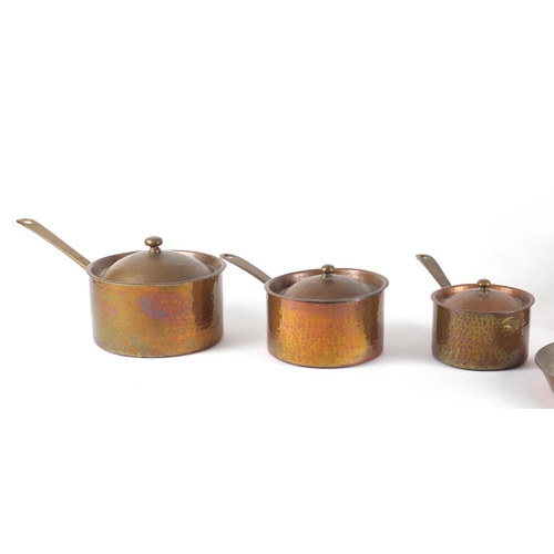 131 - Graduated set of three copper and brass saucepans, a pan and a kettle