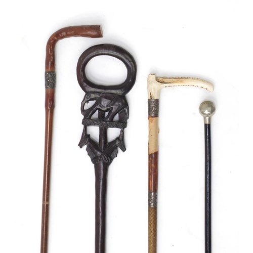 81 - Two walking sticks, a swagger stick and a riding crop, two with silver collars