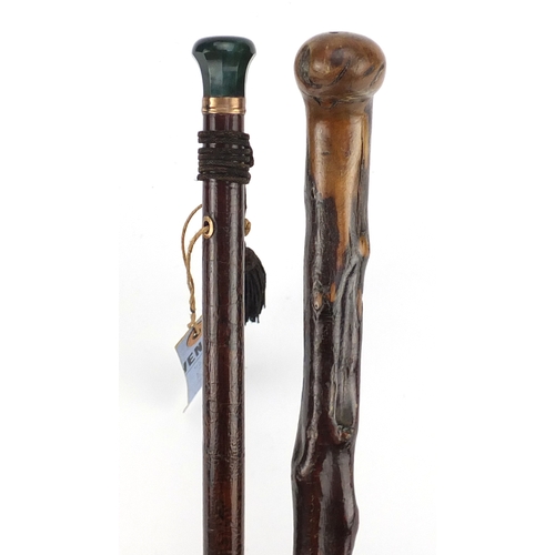83 - Two walking sticks comprising one with green hardstone pommel and a 19th century Irish example with ... 