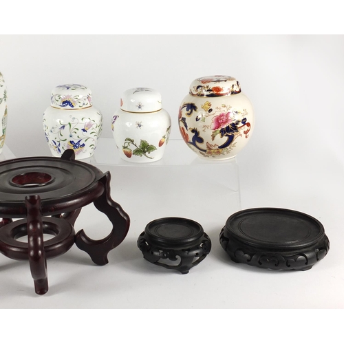 177 - Six porcelain lidded ginger jars and five hardwood stands including Masons and Coalport
