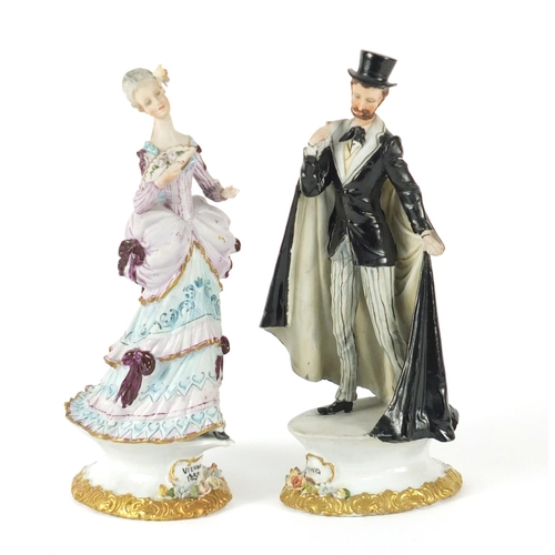 113 - Pair of Capodimonte porcelain figures of a male and female in formal dress, 20.5cm high