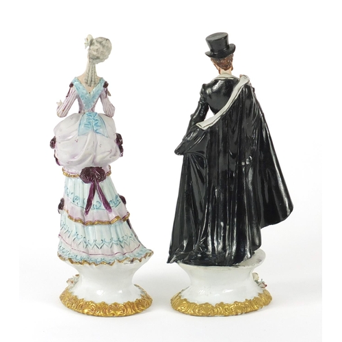 113 - Pair of Capodimonte porcelain figures of a male and female in formal dress, 20.5cm high