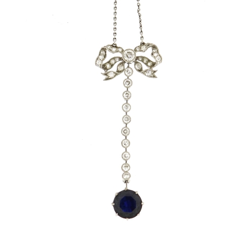 835 - Unmarked white metal sapphire and diamond bow necklace, tests as 18ct gold, the pendant 4.5cm long, ... 
