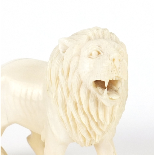 542 - Good pair of Indian carved ivory lions, each 11cm wide