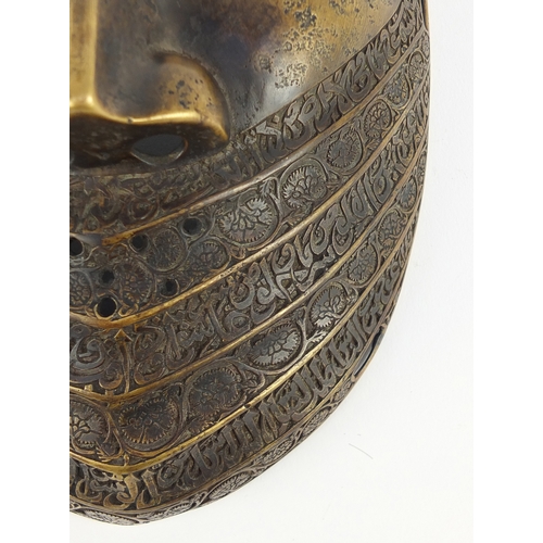 521 - Good antique Persian bronze war mask, finely engraved with flowers and calligraphy, 24cm high