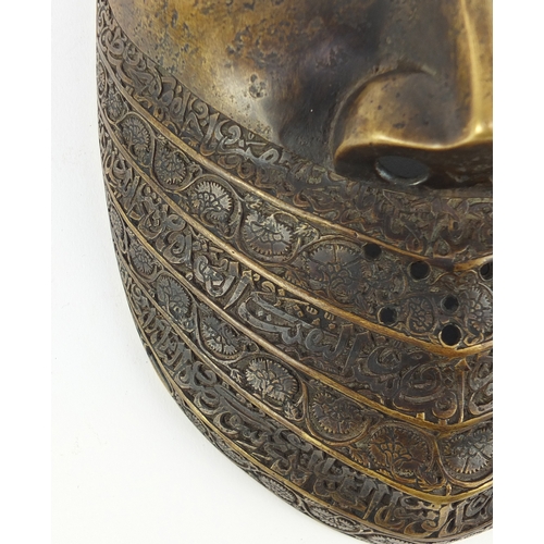 521 - Good antique Persian bronze war mask, finely engraved with flowers and calligraphy, 24cm high