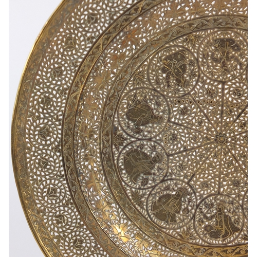 571 - Good Persian gilt copper dish, finely pierced and engraved with figures and flowers, 23cm in diamete... 