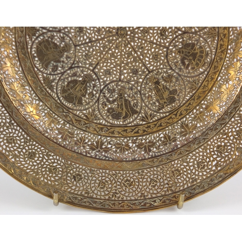 571 - Good Persian gilt copper dish, finely pierced and engraved with figures and flowers, 23cm in diamete... 