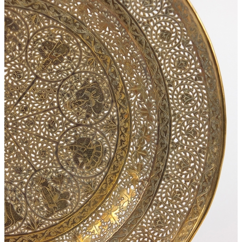 571 - Good Persian gilt copper dish, finely pierced and engraved with figures and flowers, 23cm in diamete... 