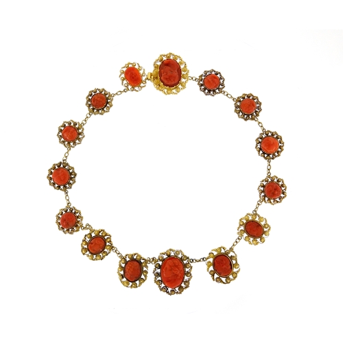 851 - 18th/19th century unmarked gold coral necklace (tests as 9ct), with 15 coral panels each carved with... 