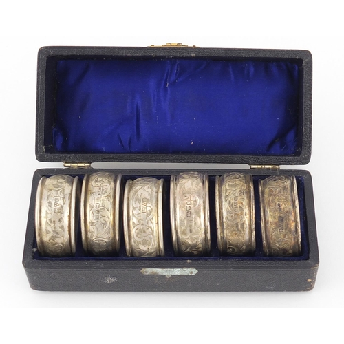 2591 - Set of six circular silver napkin rings with floral chased decoration, Chester 1903, housed in a fit... 