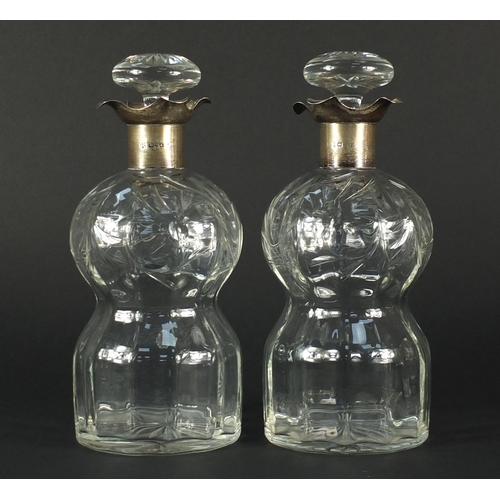 2572 - Pair of cut glass decanters with silver collars, both etched with flowers, each 22cm high