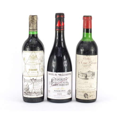 2410 - Three bottles of red wine comprising a bottle of 1970 Chateau La Tour Pibran Pauillac, bottle of 199... 