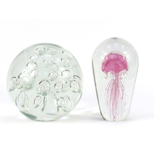 2396 - Two large glass paperweights both with internal bubbles, the largest 19cm high