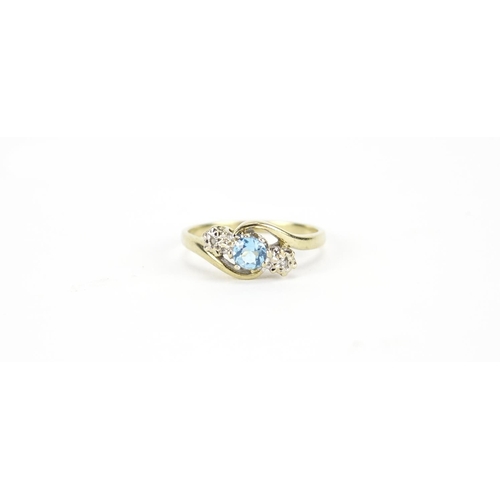 2693 - 9ct gold blue stone and diamond crossover ring, size M, 2.1g
