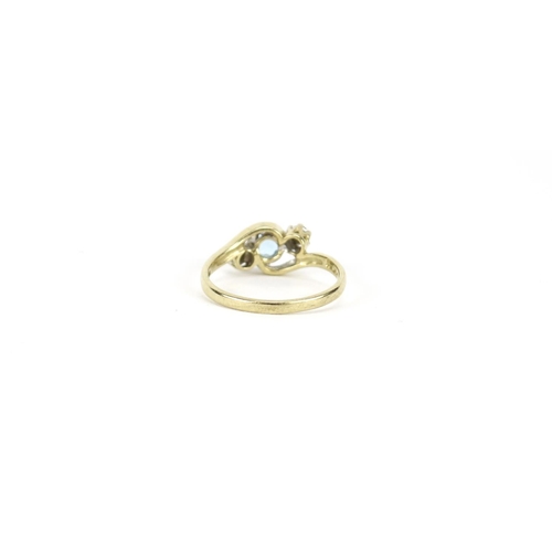 2693 - 9ct gold blue stone and diamond crossover ring, size M, 2.1g