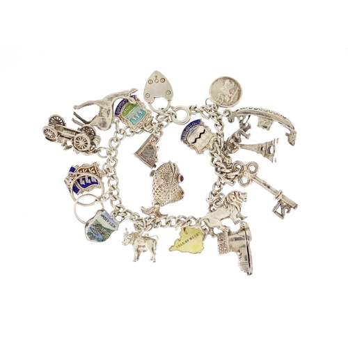 2913 - Silver charm bracelet with a selection of mostly silver charms including classic car, fish, lion and... 