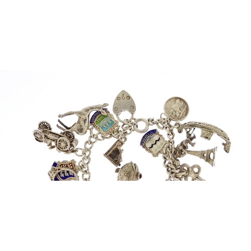 2913 - Silver charm bracelet with a selection of mostly silver charms including classic car, fish, lion and... 