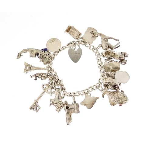 2913 - Silver charm bracelet with a selection of mostly silver charms including classic car, fish, lion and... 