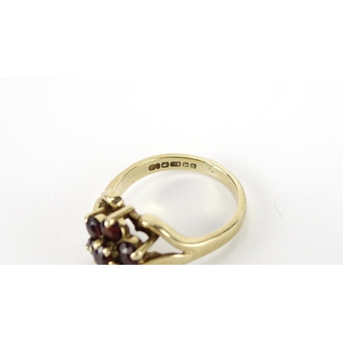 2683 - Two 9ct gold garnet flower head rings, size O and H, 4.7g