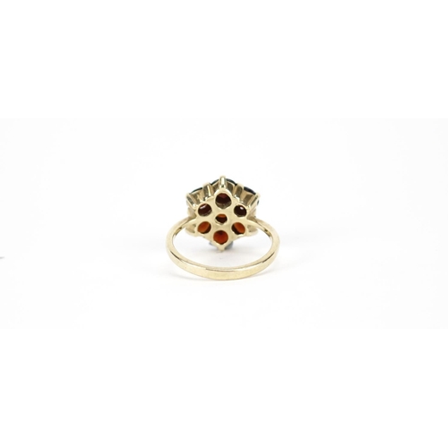 2900 - 9ct gold garnet flower head ring, size L, 4.0g