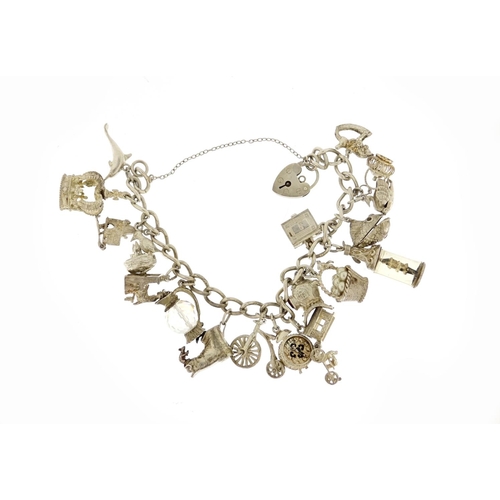 2690 - Silver charm bracelet with a selection of mostly silver charms including divers helmet, alarm clock,... 