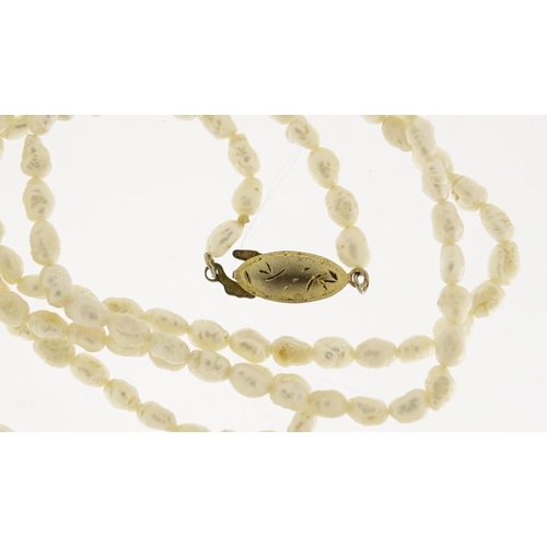 2925 - Three pearl necklaces, two with 9ct gold clasps, 53.6g