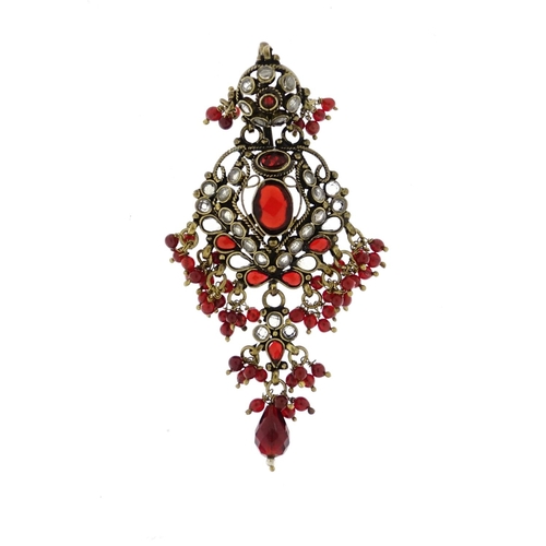 2949 - Indian gilt metal red and clear glass head piece, 9cm in length