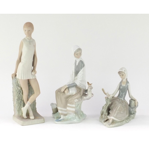 2313 - Three Lladro figurines comprising a tennis player and two girls seated with birds, the largest 32cm ... 