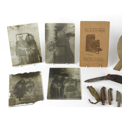 526 - Objects including Military interest black and white glass camera slides, trench art photo frame, bin... 