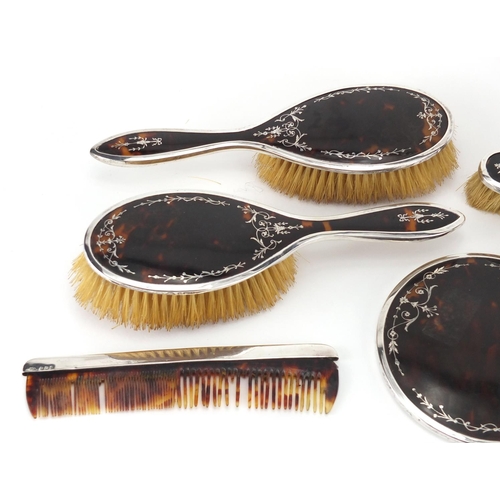 2584 - Edwardian silver and tortoiseshell floral pique six piece dressing table set, hand mirror, two pairs... 