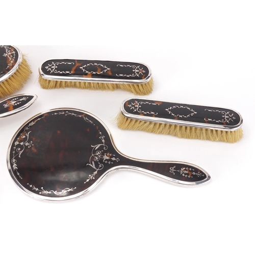 2584 - Edwardian silver and tortoiseshell floral pique six piece dressing table set, hand mirror, two pairs... 