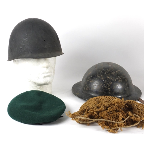 543 - Three Military interest helmets and two berets