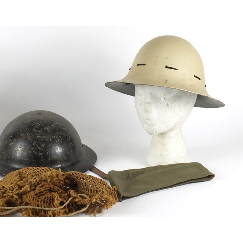 543 - Three Military interest helmets and two berets
