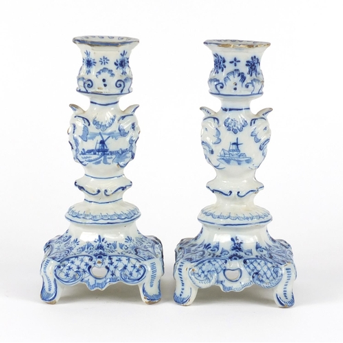 241 - Pair of Delft blue and white candlesticks with grotesque mask columns, 24cm high
