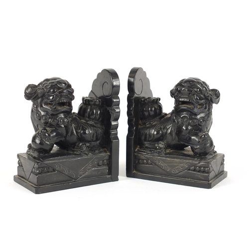 252 - Pair of Chinese ebony carved stone dog-of-foo bookends, 16.5cm high