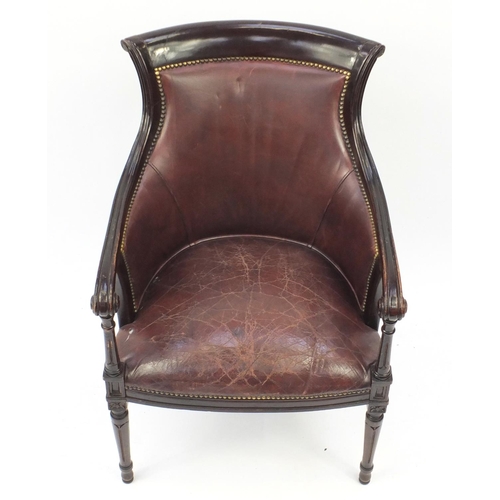 2077 - Mahogany and brown leather library chair on tapering legs, 91cm high
