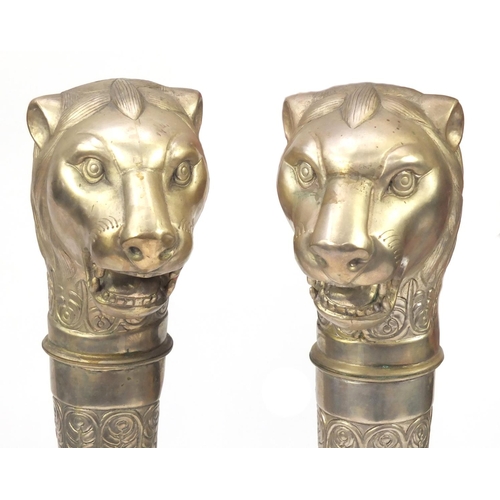 2153 - Pair of silvered metal lion head torch design columns, each 104cm in length